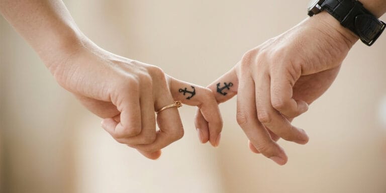 Two hands gently reaching toward each other, symbolising touch deprivation and reconnection