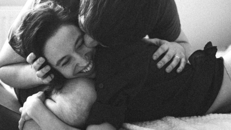 Couple embracing intimately, symbolising connection through sex and wellness.