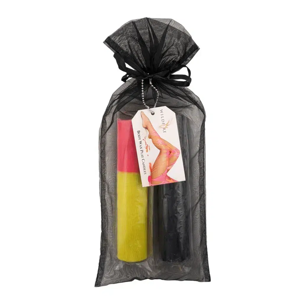 Wildfire Candle Wax Play set featuring Black and Fluoro Pink & Yellow candles, elegantly packaged in a black organza bag with a product tag attached.