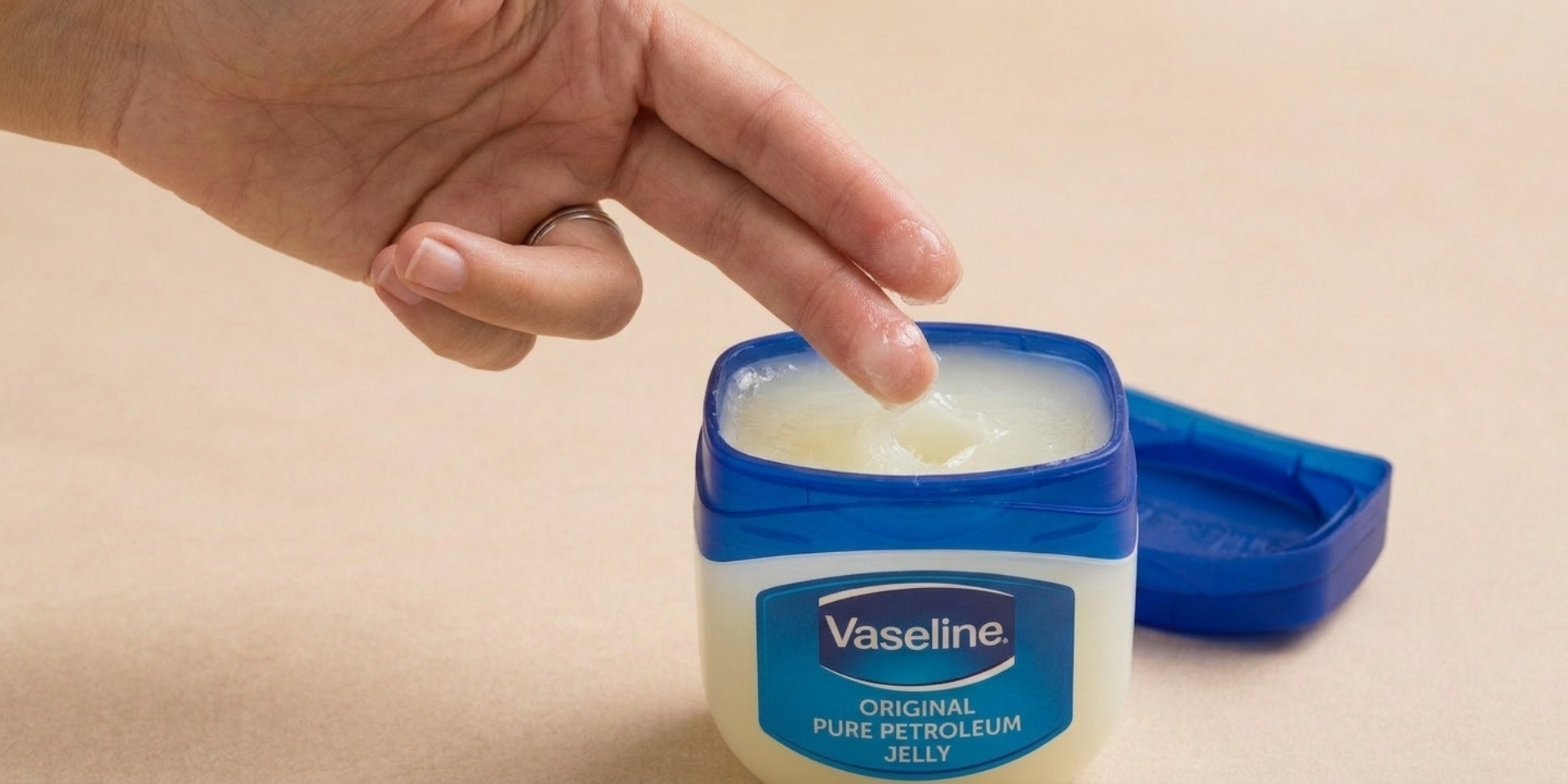 Open tub of Vaseline petroleum jelly for article about whether Vaseline can be used as lube
