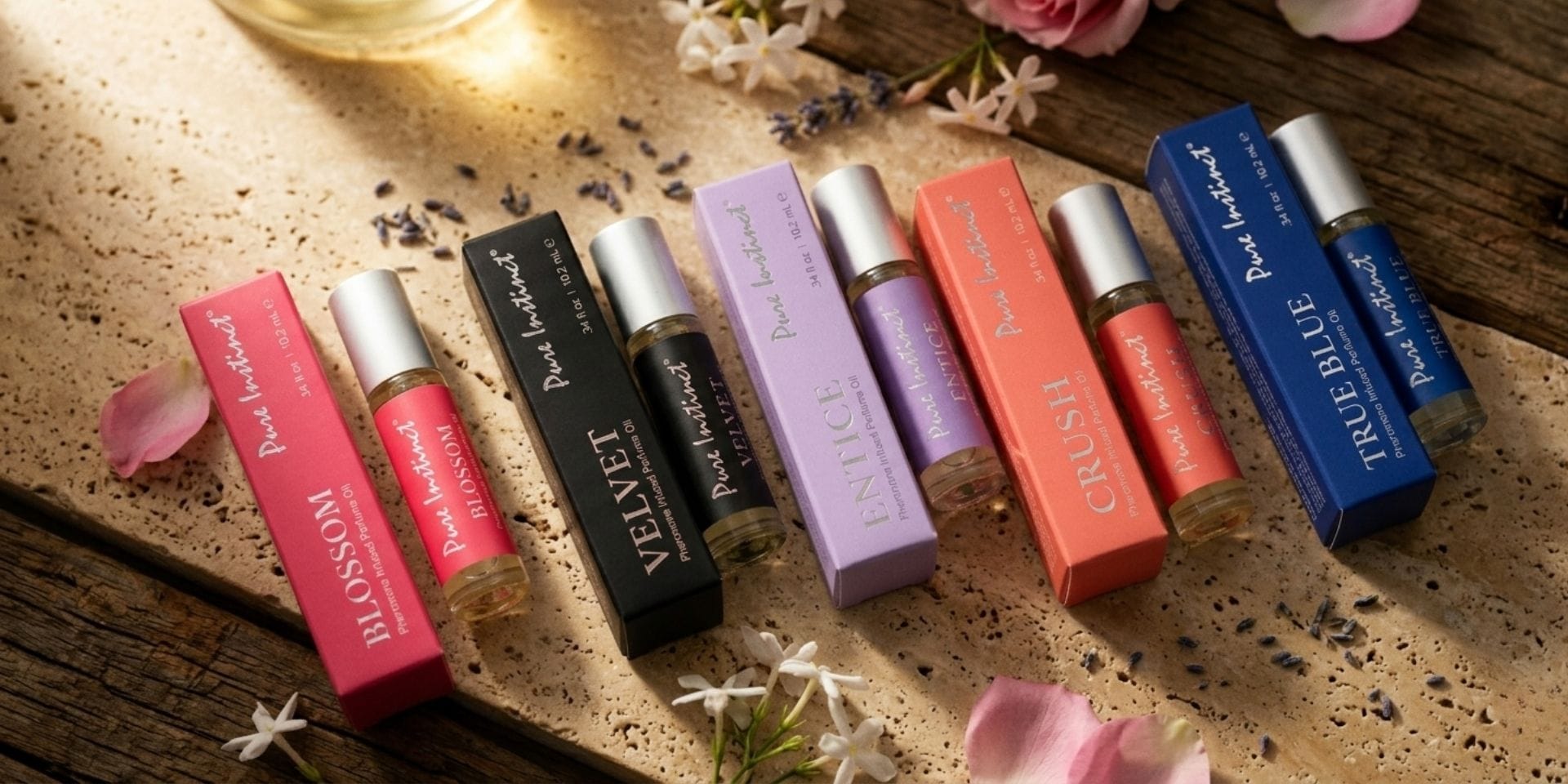 Perfume oil roll-ons and fragrance oils arranged on a timber surface