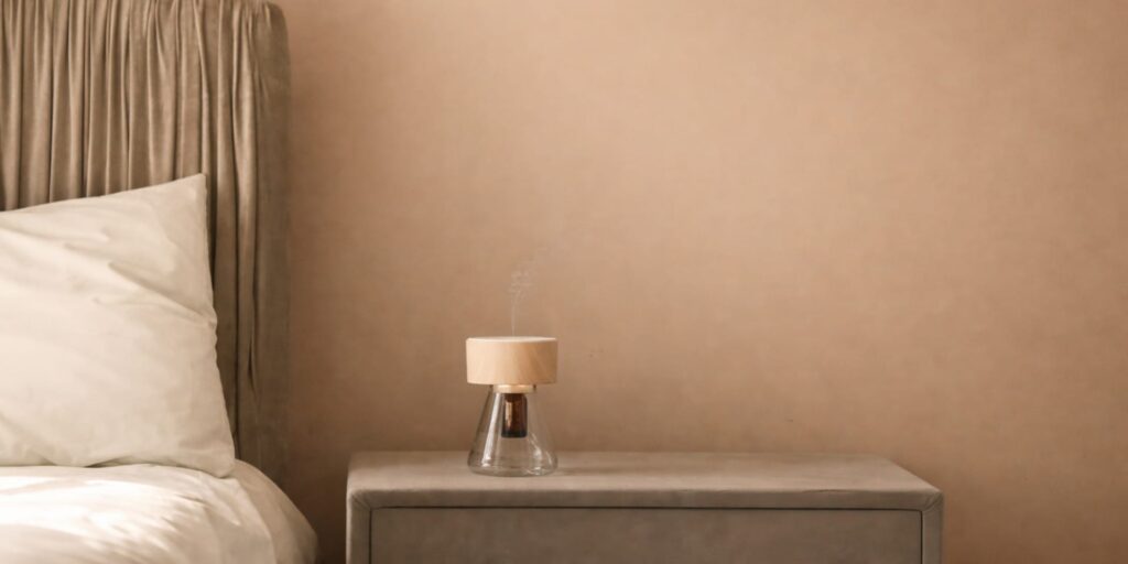 Essential oil diffuser releasing gentle vapour in a calm bedroom, part of a scent-led aphrodisiac essential oils ritual