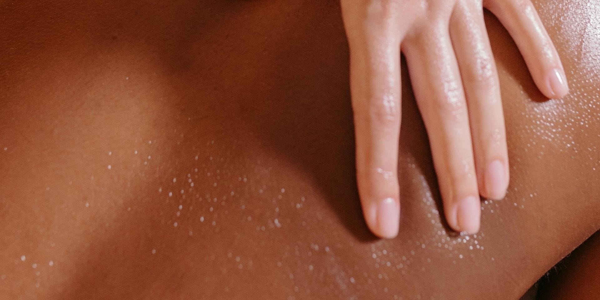 Sensual massage oils used during slow, attentive touch on bare skin