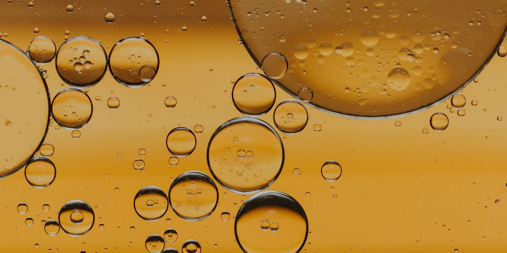 Essential oils in Wildfire natural body oils Golden oil droplets representing essential oils used in natural body oil