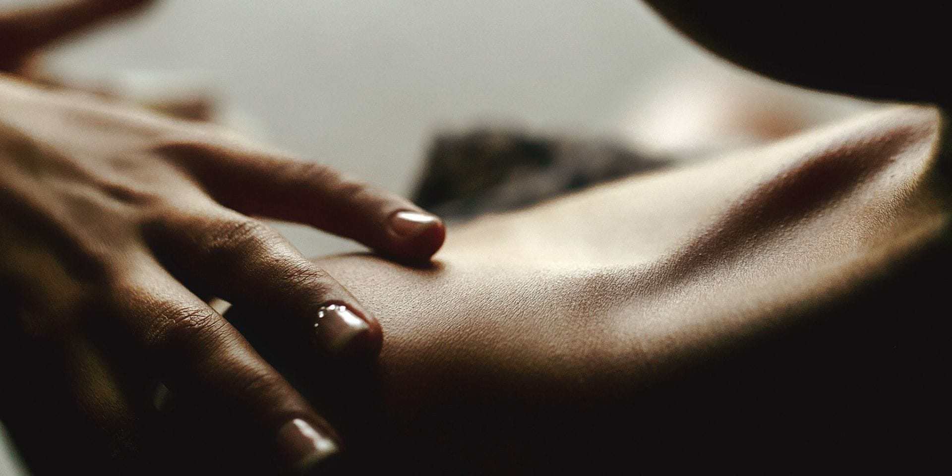 Wildfire natural body oils for skin nourishment and connection Hand resting on shoulder during a natural body oil skin care ritual