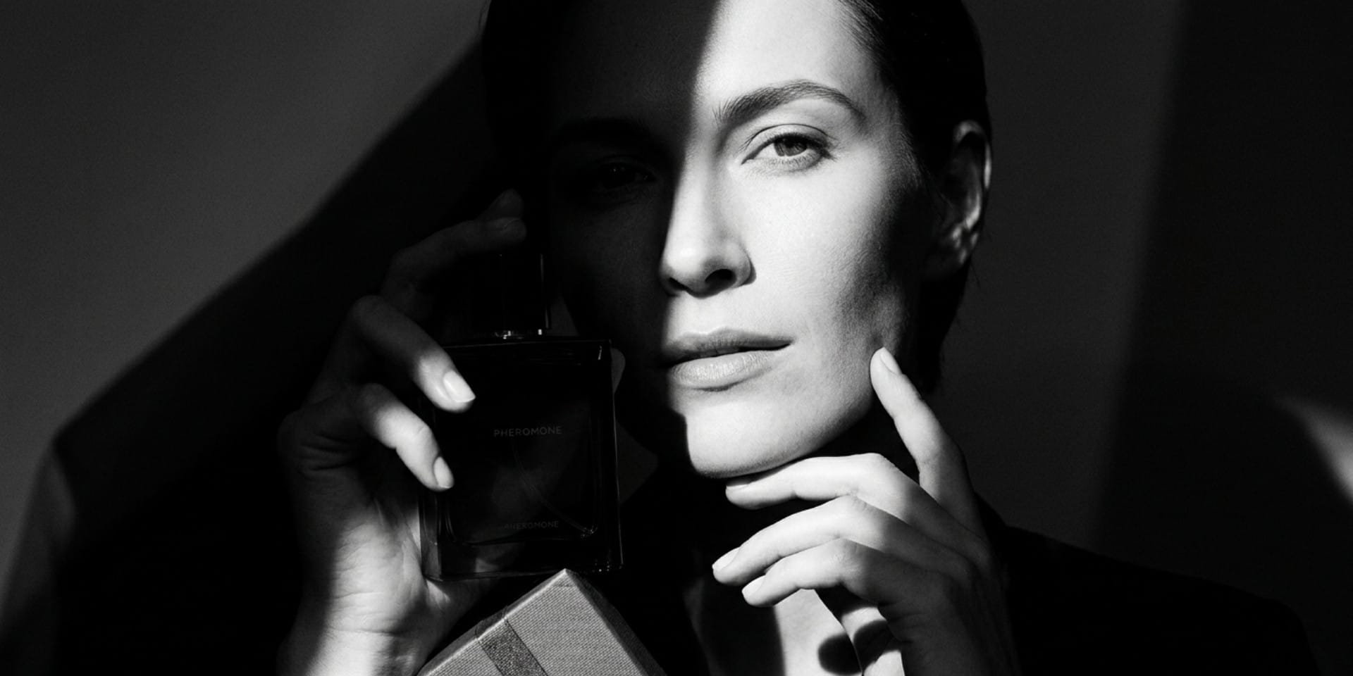 Woman holding perfume while choosing the best perfume to give as a gift
