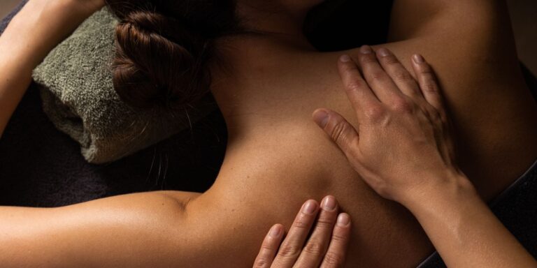 Hands giving a calming full-body massage designed to support relaxation and connection