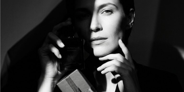 Woman holding perfume bottle with gift box representing perfume gift sets in Australia